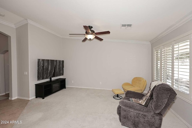 sitting room featuring ornamental molding, ceiling fan, and plenty of natural light