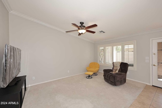 sitting room featuring crown molding, light tile patterned floors, and ceiling fan