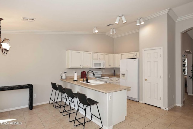 kitchen featuring ornamental molding, white cabinets, white appliances, and kitchen peninsula