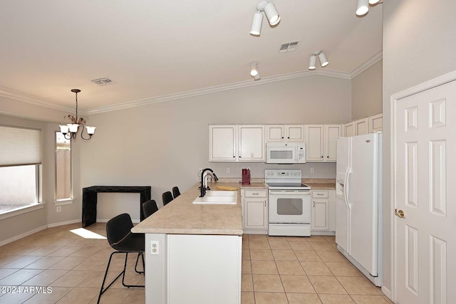 kitchen with pendant lighting, lofted ceiling, sink, white appliances, and crown molding