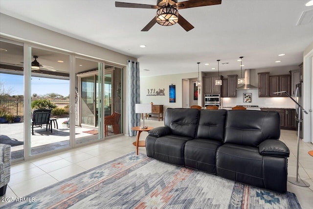 tiled living room featuring ceiling fan