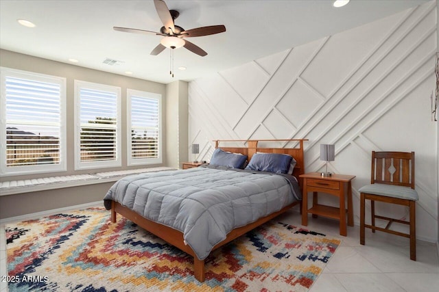 tiled bedroom with multiple windows and ceiling fan