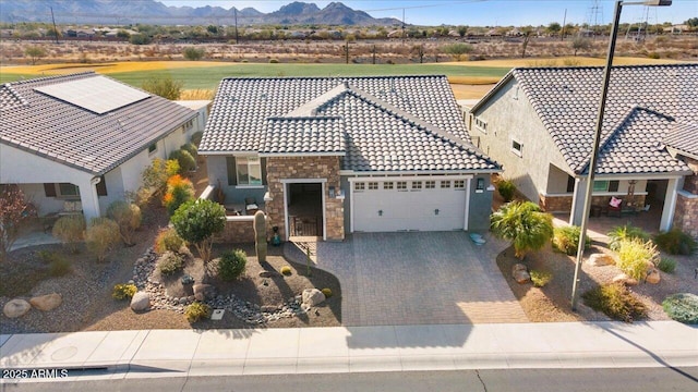 view of front of home featuring a garage and a mountain view