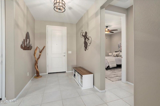 entrance foyer featuring light tile patterned floors and ceiling fan