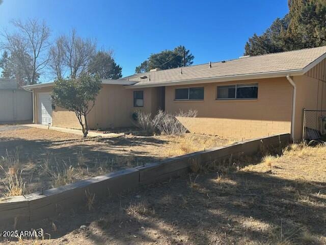 back of property featuring a garage