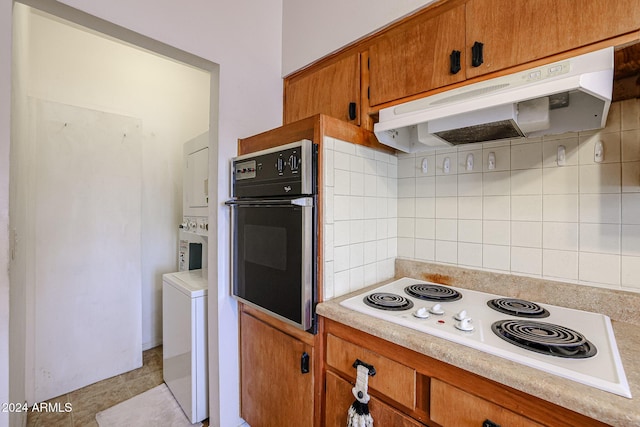 kitchen featuring decorative backsplash, oven, and white electric stovetop