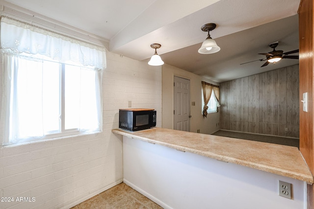 kitchen with pendant lighting, light tile patterned floors, ceiling fan, and a healthy amount of sunlight