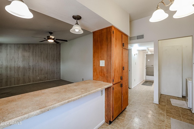 kitchen featuring decorative light fixtures and ceiling fan with notable chandelier