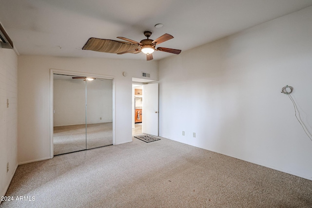 unfurnished bedroom with carpet, a closet, and ceiling fan