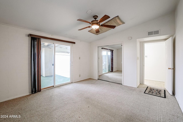 carpeted empty room with ceiling fan and vaulted ceiling