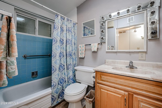 full bathroom featuring shower / bath combination with curtain, toilet, and vanity