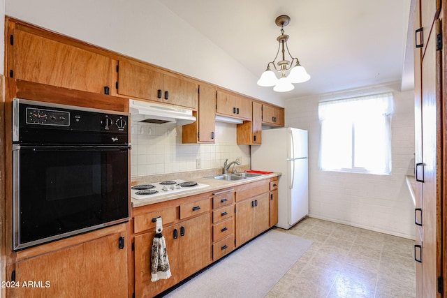 kitchen featuring pendant lighting, white appliances, sink, vaulted ceiling, and a chandelier