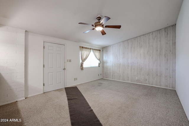 spare room featuring carpet flooring and ceiling fan