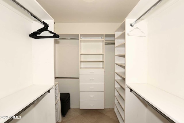 walk in closet featuring light tile patterned floors