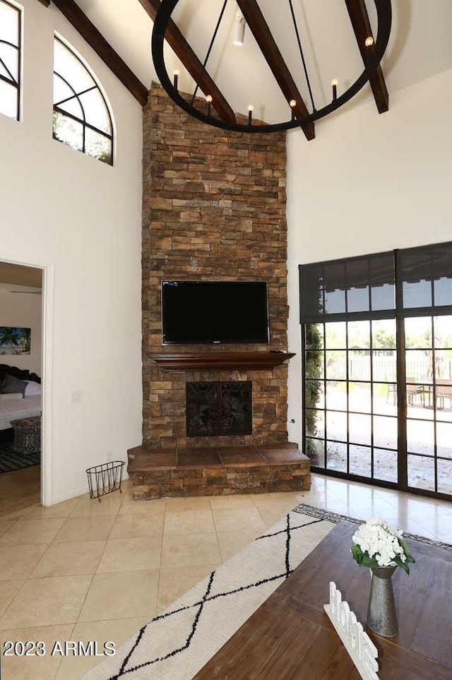 unfurnished living room with beamed ceiling, high vaulted ceiling, tile patterned floors, and a fireplace