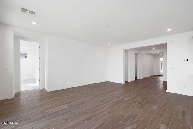 spare room with dark hardwood / wood-style flooring