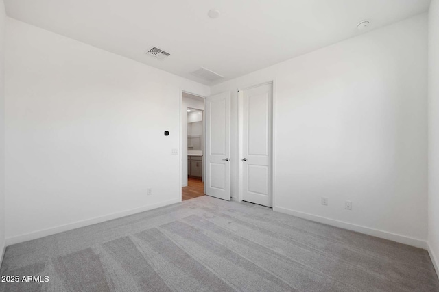 empty room featuring light carpet