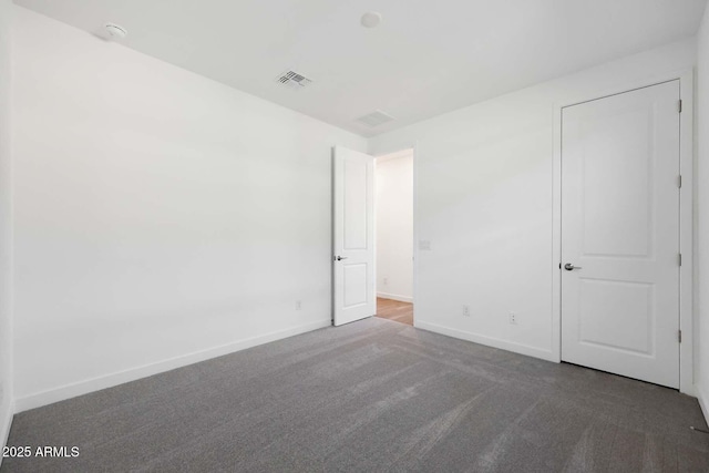 unfurnished bedroom with dark colored carpet