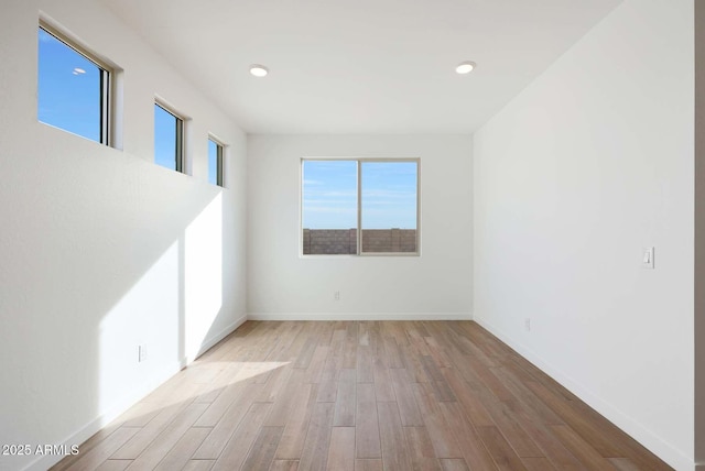 spare room with light hardwood / wood-style flooring