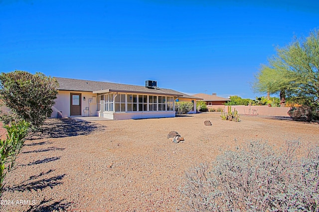 rear view of house featuring a sunroom