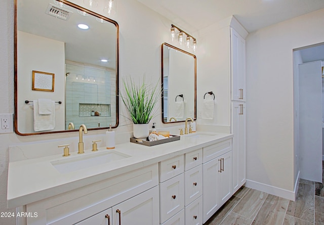 bathroom with vanity and a shower with shower door