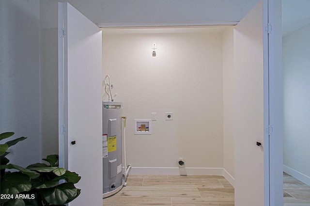 laundry room featuring electric dryer hookup, electric water heater, hookup for a washing machine, and light hardwood / wood-style flooring