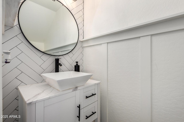 bathroom featuring tile walls, tasteful backsplash, and vanity