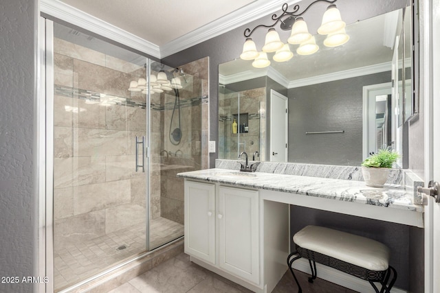 bathroom featuring a chandelier, a stall shower, ornamental molding, and a textured wall