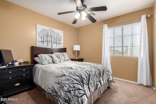 carpeted bedroom with visible vents, ceiling fan, and baseboards