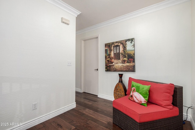 living area with crown molding, wood finished floors, and baseboards