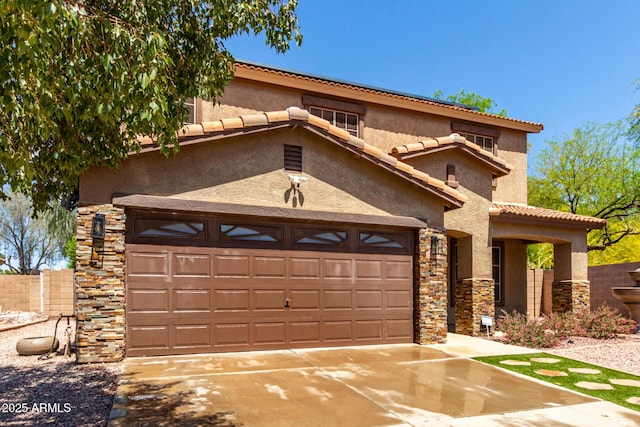 view of front of property featuring stucco siding, a tiled roof, a garage, driveway, and stone siding