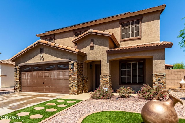 mediterranean / spanish-style house featuring a tile roof, a garage, driveway, stone siding, and stucco siding