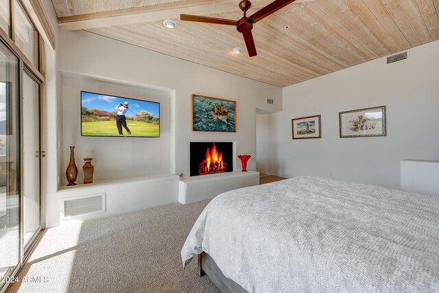 carpeted bedroom with wood ceiling, beam ceiling, ceiling fan, and a closet