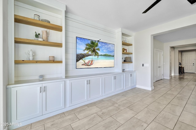 interior space with baseboards and built in shelves