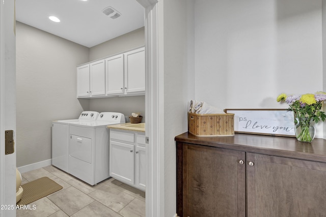 laundry area featuring baseboards, washing machine and dryer, visible vents, and cabinet space