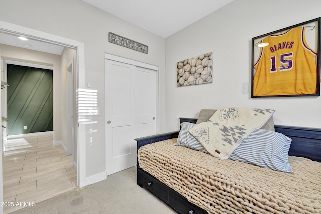 bedroom featuring a closet, carpet flooring, and baseboards