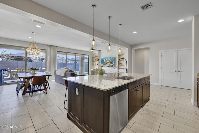 kitchen with visible vents, dishwasher, dark brown cabinets, a sink, and open floor plan