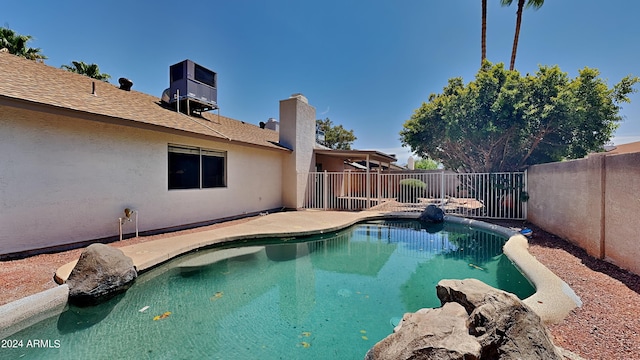 view of pool with a patio and central air condition unit