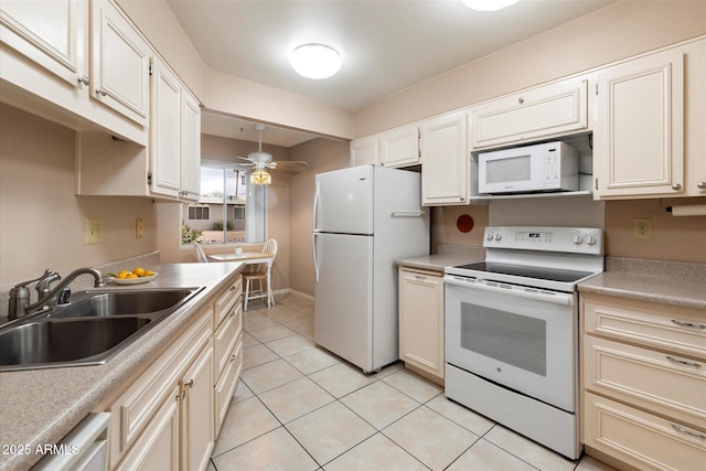 kitchen with light tile patterned flooring, decorative light fixtures, sink, ceiling fan, and white appliances