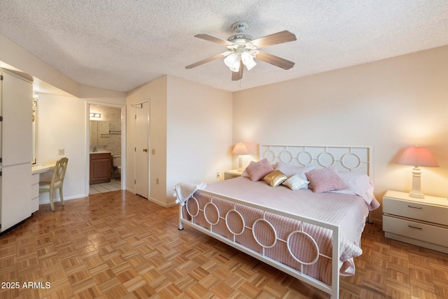 bedroom featuring ensuite bath, light parquet floors, a textured ceiling, and ceiling fan