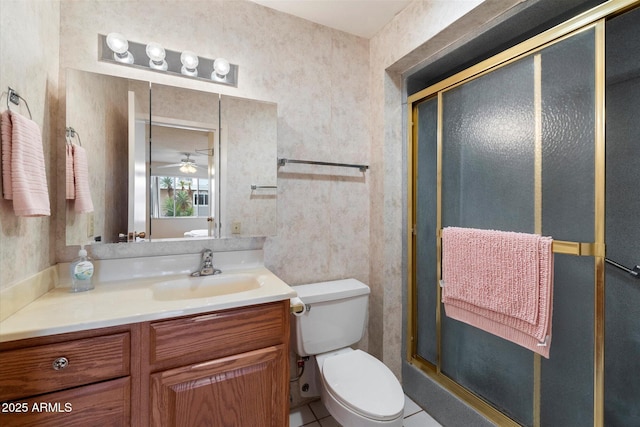 bathroom with vanity, tile patterned floors, a shower with door, and toilet