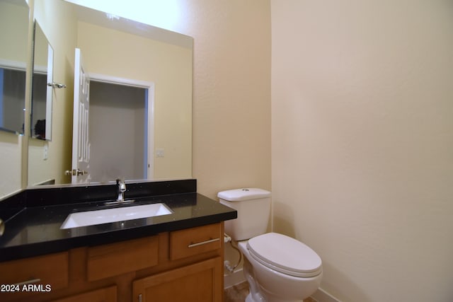 bathroom featuring large vanity and toilet