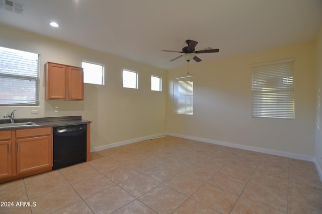 kitchen featuring black dishwasher, ceiling fan, sink, and light tile flooring