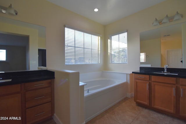 bathroom with a bath, tile floors, and double vanity