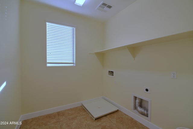 clothes washing area with washer hookup, hookup for an electric dryer, and light tile floors