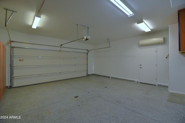 garage featuring a garage door opener and a wall mounted air conditioner