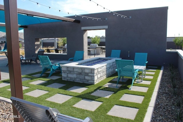 view of patio featuring outdoor dining area, outdoor dry bar, and an outdoor fire pit