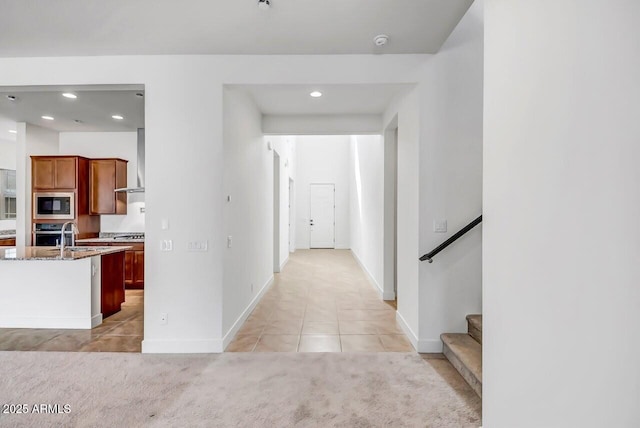 hallway with stairs, light tile patterned floors, recessed lighting, and baseboards