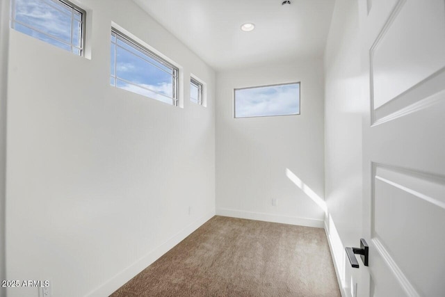 basement featuring recessed lighting, baseboards, and carpet