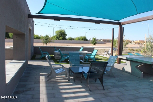 view of patio featuring outdoor dining area and fence